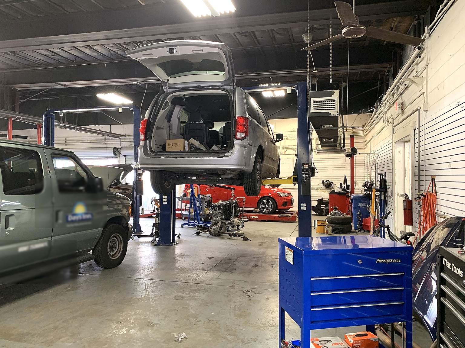 McCoy Enterprises auto repair shop in Orlando — a vehicle up on a lift in the service bays