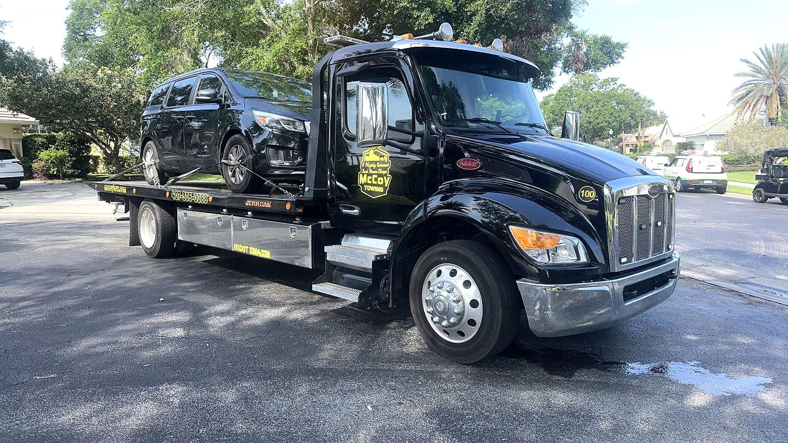 McCoy Towing truck carrying a customer’s car to the McCoy Enterprises shop in Orlando