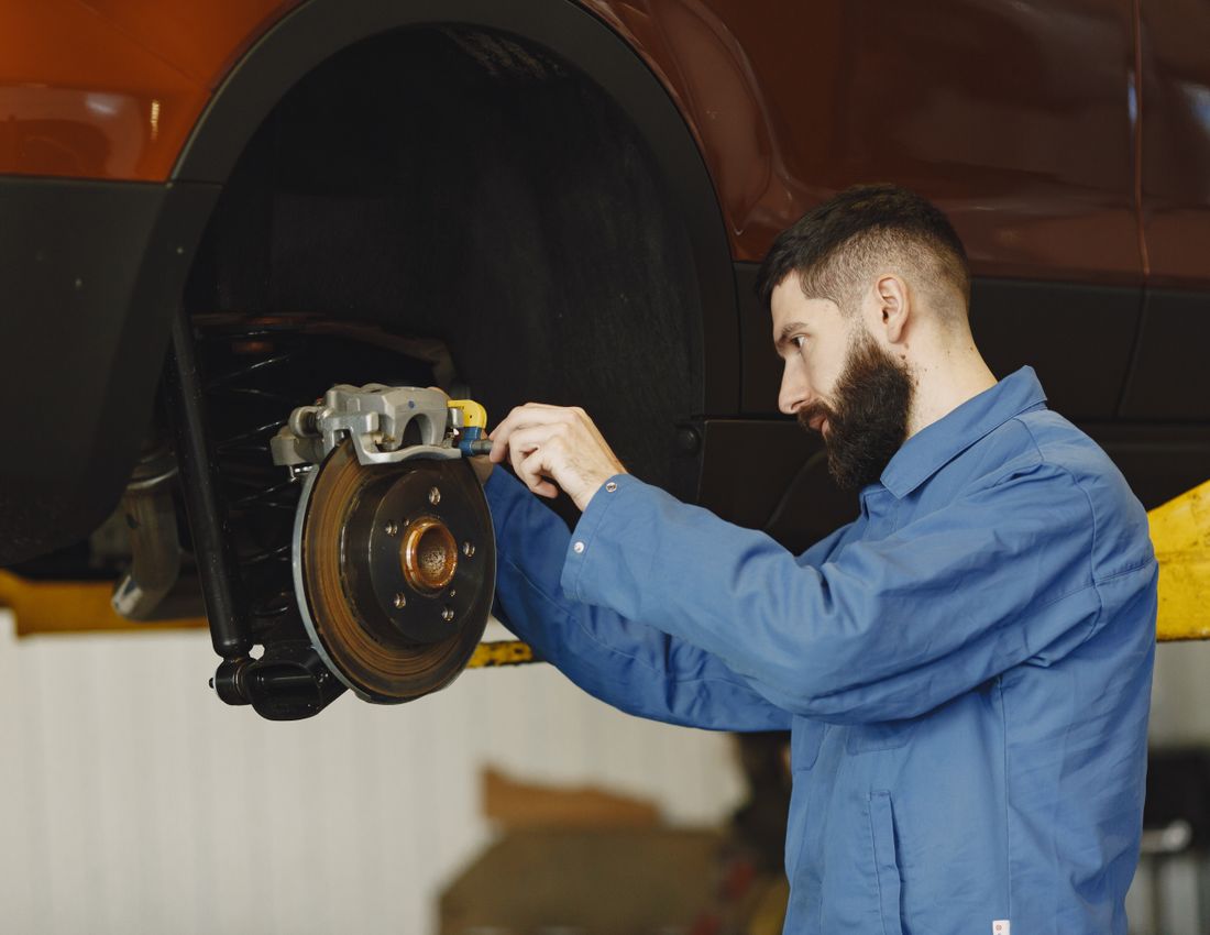 Mechanic replacing car brakes