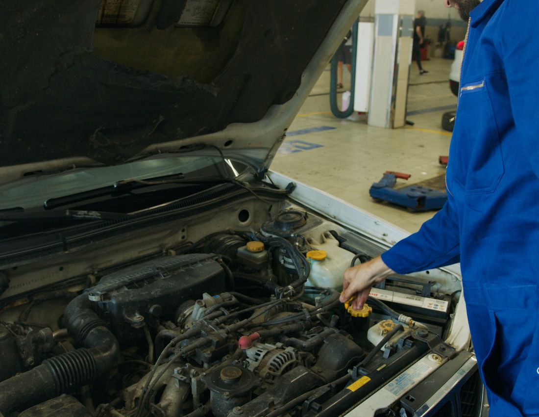 Mobile mechanic performing on-site car repair