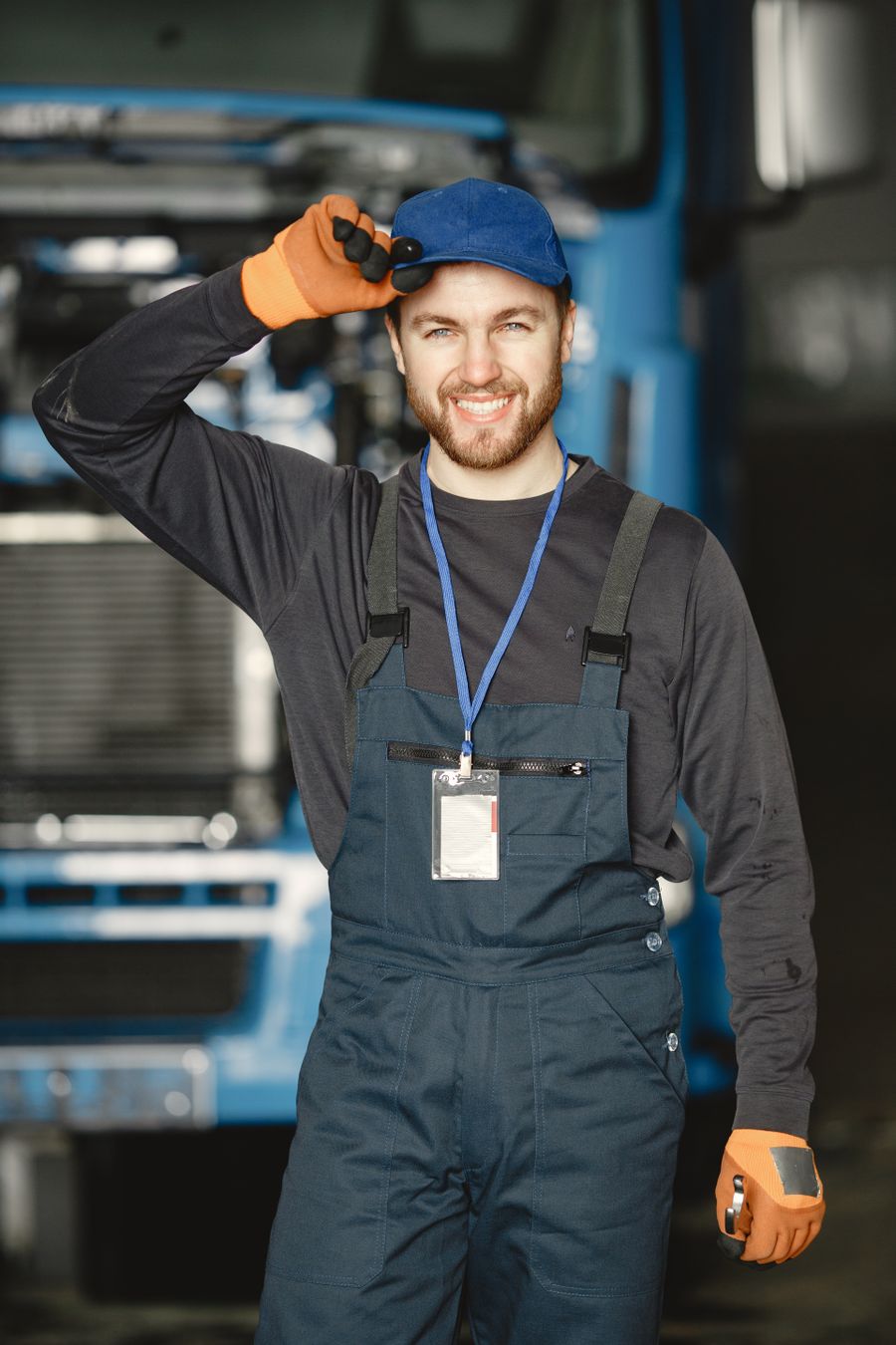 Friendly McCoy Enterprises auto mechanic welcoming customers in the Orlando shop