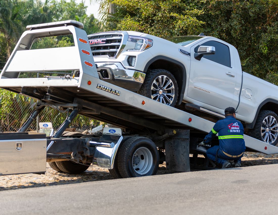 Flatbed tow truck loading a vehicle in Orlando